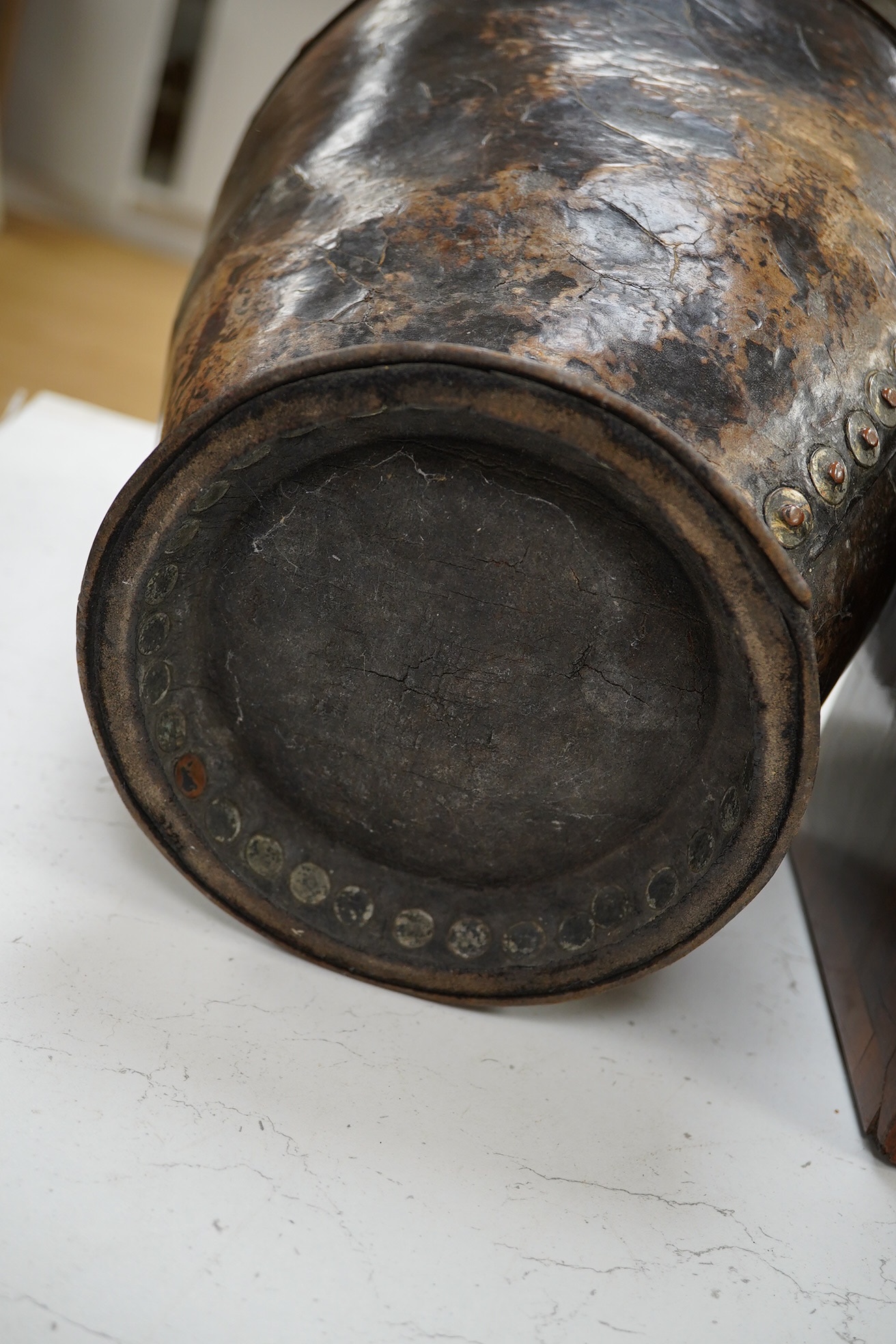 A Georgian mounted leather fire bucket (waste paper bin), 27cm high. Condition - fair